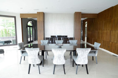 Example of a large minimalist marble floor and white floor enclosed dining room design in New York with white walls and no fireplace