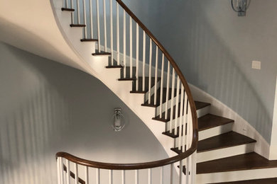 Staircase - craftsman wooden curved wood railing staircase idea in Chicago with wooden risers