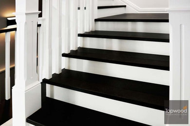 This is an example of a modern wood u-shaped staircase in Perth with painted wood risers and wood railing.