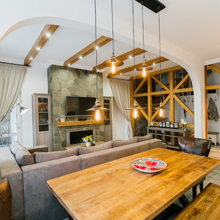 Medium sized mediterranean open plan living room in Other with white walls, laminate floors, a ribbon fireplace, a stone fireplace surround, a wall mounted tv and beige floors.