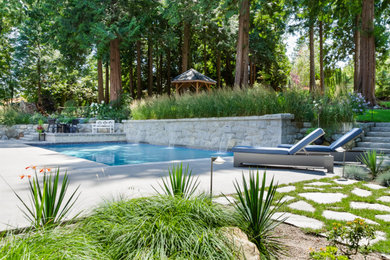 Arts and crafts backyard concrete paver and rectangular hot tub photo in Vancouver