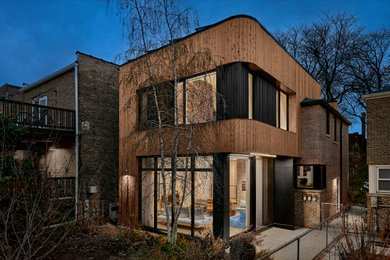 Mid-sized minimalist brown split-level wood house exterior photo in Chicago