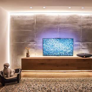 Inspiration for a large contemporary open concept carpeted and multicolored floor home theater remodel in Dortmund with gray walls and a wall-mounted tv