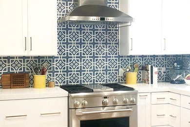 Inspiration for a modern light wood floor kitchen remodel in Phoenix with white cabinets, blue backsplash, cement tile backsplash, stainless steel appliances and white countertops