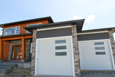 Inspiration for a large contemporary gray two-story mixed siding exterior home remodel in Vancouver