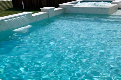Inspiration for a modern rectangular swimming pool in Houston with natural stone paving.