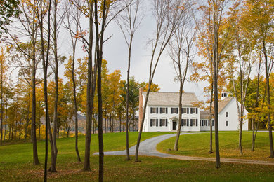 Example of a classic white two-story exterior home design in Burlington