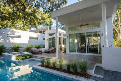 Large trendy backyard deck photo in Tampa with a roof extension