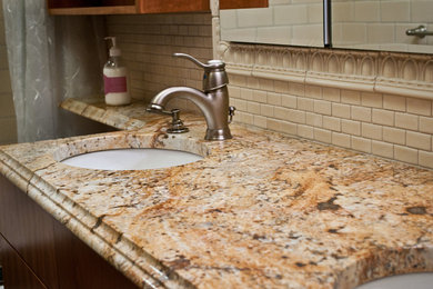 Example of a mid-sized classic master beige tile and ceramic tile slate floor alcove shower design in Other with an undermount sink, furniture-like cabinets, medium tone wood cabinets, granite countertops and beige walls