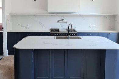 Inspiration for a large traditional eat-in kitchen in Sydney with a double-bowl sink, shaker cabinets, blue cabinets, light hardwood floors and with island.