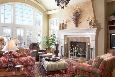 Mid-sized traditional formal enclosed living room in Milwaukee with beige walls, medium hardwood floors, a standard fireplace, a tile fireplace surround, no tv and brown floor.
