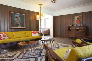 Eclectic living room in Los Angeles with brown walls.