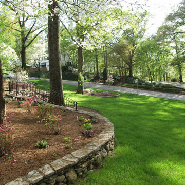 A stone retaining wall was the best solution to reduce the slope of this front y