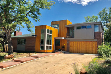 Photo of a mid-sized midcentury two-storey brick multi-coloured house exterior in Denver with a hip roof and a shingle roof.