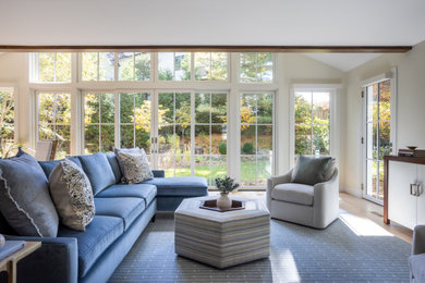 Example of a mid-sized transitional open concept light wood floor and coffered ceiling family room design in DC Metro with white walls and a concealed tv