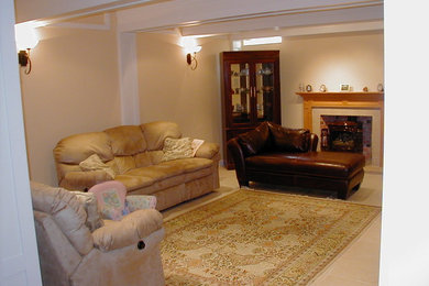 Inspiration for a huge timeless look-out ceramic tile basement remodel in Philadelphia with beige walls, a standard fireplace and a stone fireplace