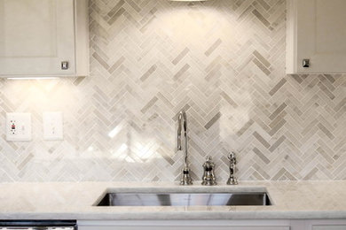 Small trendy l-shaped dark wood floor enclosed kitchen photo in DC Metro with a single-bowl sink, shaker cabinets, white cabinets, quartzite countertops, white backsplash, mosaic tile backsplash, stainless steel appliances and no island