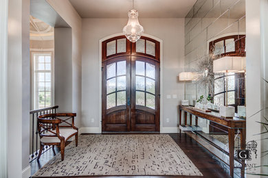 Inspiration for a large traditional front door in Denver with beige walls, concrete floors, a double front door, a dark wood front door and beige floor.