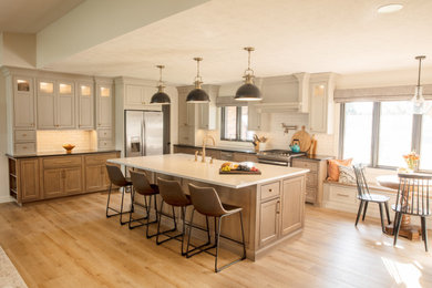 Large country l-shaped eat-in kitchen photo in Other with a farmhouse sink, shaker cabinets, medium tone wood cabinets, soapstone countertops, an island and black countertops