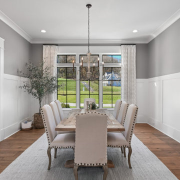 Transitional Dining & Living Room with Vaulted Beams and Stone Fireplace