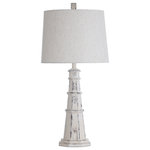 Stylecraft - Berwyn Light House Table Lamp With Tapered Drum Shade, Distressed White - This coastal lighthouse table lamp makes a charming addition to any living room, dining room or office. The carefully crafted polyresin frame features a distressed white finish. The detailing of the lighthouse body is contrasted by the smooth oatmeal shade, made from a linen and polyester blend. The perfect lamp for bringing coastal style to interior decor.