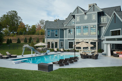 Example of a huge classic blue three-story concrete fiberboard exterior home design in Grand Rapids with a metal roof