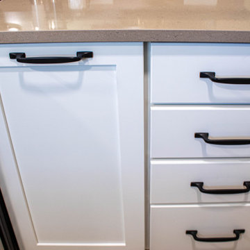 White Kitchen with Blue Tiled Backsplash and Two Tier Island