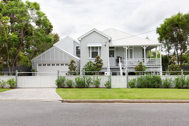 Mid-sized eclectic two-storey grey house exterior in Brisbane with wood siding, a gable roof and a metal roof.