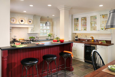 Inspiration for a traditional eat-in kitchen in Newark with stainless steel appliances, an undermount sink, wood benchtops, glass-front cabinets and white cabinets.