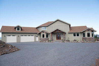 Mid-sized rustic green two-story vinyl house exterior idea in Other with a hip roof and a shingle roof