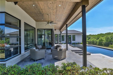Inspiration for a large contemporary backyard concrete paver and rectangular lap hot tub remodel in Dallas