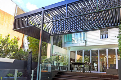 This is an example of a mid-sized contemporary home design in Brisbane.