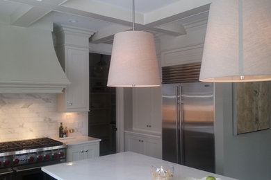 Mid-sized transitional l-shaped eat-in kitchen photo in Grand Rapids with shaker cabinets, white cabinets, marble countertops, gray backsplash, marble backsplash, stainless steel appliances and an island