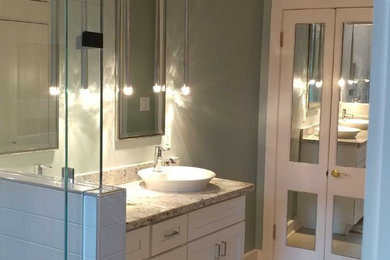 Inspiration for a mid-sized transitional master white tile and ceramic tile ceramic tile and white floor alcove shower remodel in New Orleans with shaker cabinets, white cabinets, blue walls, a vessel sink, granite countertops and a hinged shower door