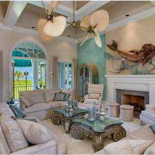 This is an example of a large mediterranean enclosed living room in Tampa with blue walls, a standard fireplace, a wooden fireplace surround and no tv.