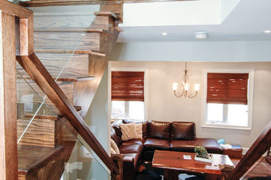 Living room - mid-sized contemporary open concept medium tone wood floor living room idea in Toronto with brown walls and a wall-mounted tv
