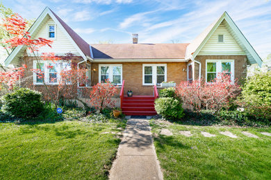 Example of a mid-sized classic red two-story brick and clapboard house exterior design in Cincinnati