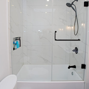 Marble-Effect Porcelain Tub-Shower with Black Fixtures | East York