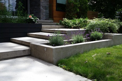 Mid-sized minimalist stamped concrete front porch idea in Toronto
