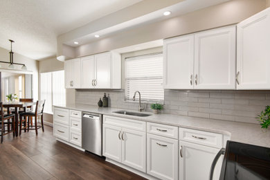Example of a mid-sized trendy galley eat-in kitchen design in Tampa with beaded inset cabinets, white cabinets, quartz countertops, no island and beige countertops