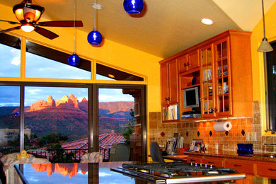 Transitional galley eat-in kitchen photo in Phoenix with an undermount sink, granite countertops, stone tile backsplash, stainless steel appliances and an island