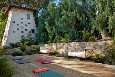 Inspiration for a mid-sized mediterranean backyard patio remodel in Santa Barbara with decking and no cover