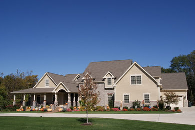 Large elegant beige two-story mixed siding exterior home photo in St Louis