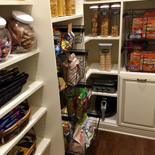 Mid-sized traditional kitchen pantry pictures - Example of a mid-sized classic l-shaped dark wood floor and brown floor kitchen pantry design in Cleveland with raised-panel cabinets, white cabinets and no island
