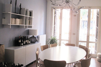 Design ideas for a large contemporary dining room in Bologna with dark hardwood floors.