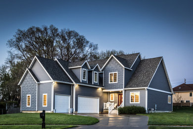 Large elegant gray two-story wood exterior home photo in Cedar Rapids with a shingle roof