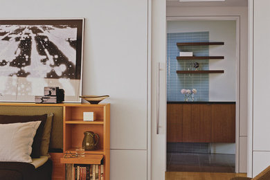 Example of a large 1950s master light wood floor bedroom design in Orange County with white walls and no fireplace