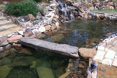 Inspiration for a large southwestern full sun backyard water fountain landscape in Dallas.