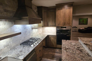 Mid-sized transitional l-shaped eat-in kitchen photo in Atlanta with shaker cabinets, dark wood cabinets, granite countertops and an island