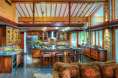 Large arts and crafts u-shaped concrete floor and gray floor open concept kitchen photo in Phoenix with a drop-in sink, recessed-panel cabinets, medium tone wood cabinets, soapstone countertops, multicolored backsplash, mosaic tile backsplash, white appliances and two islands